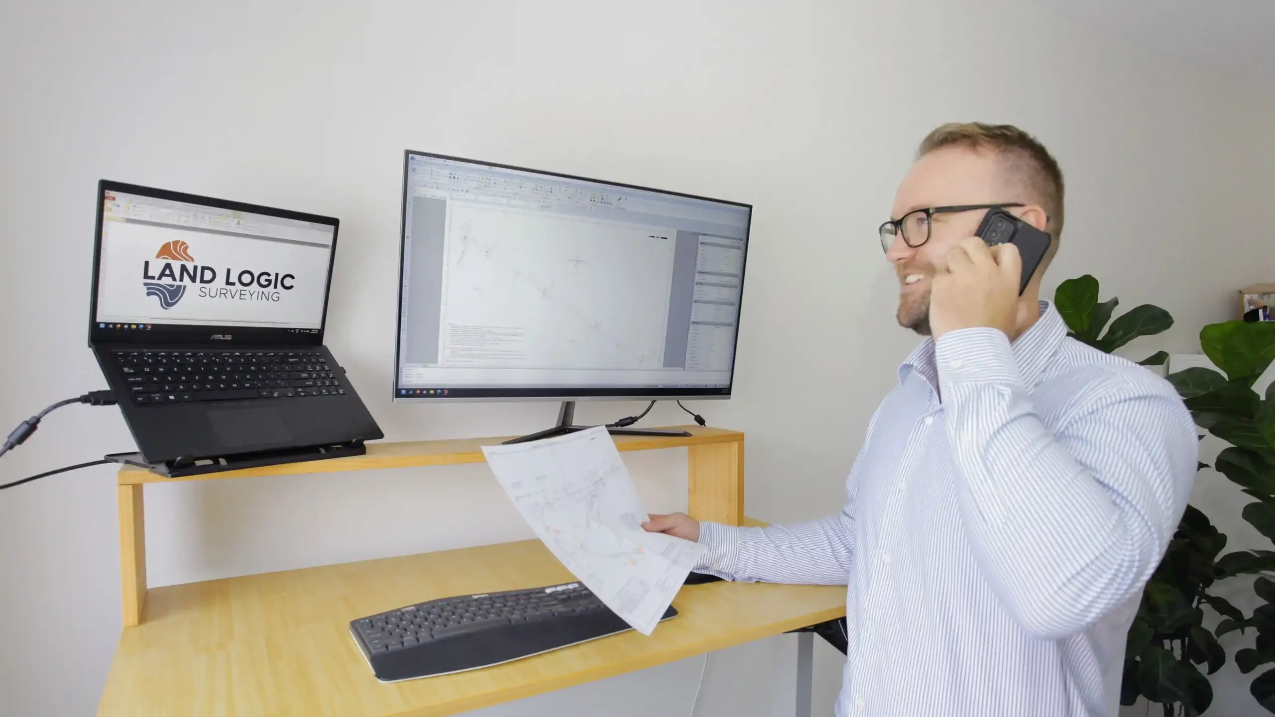 Land Logic Surveying director consulting with client by phone in Sydney office