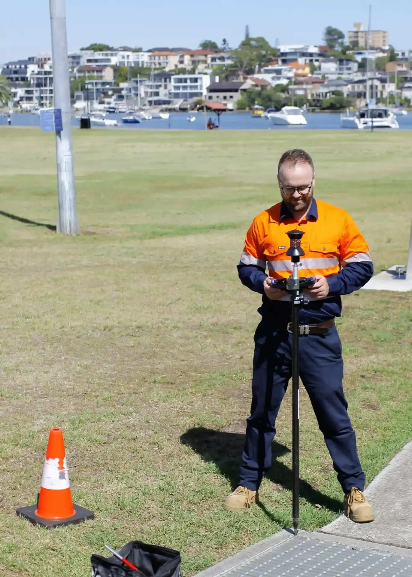 Surveyor measuring stormwater infrastructure with robotic total station in Five Dock Sydney